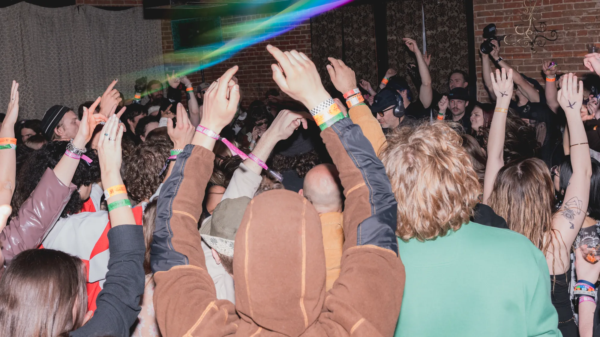 Guests raising their hands on the dance floor